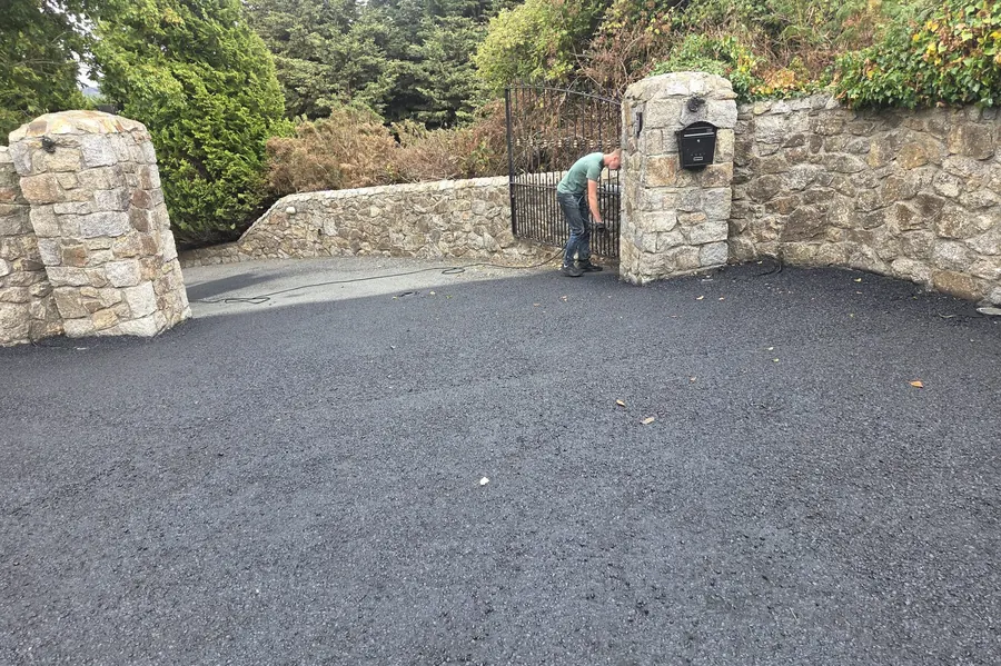 Tarmac driveway with stone pillars being cleaned at a County Kilkenny property