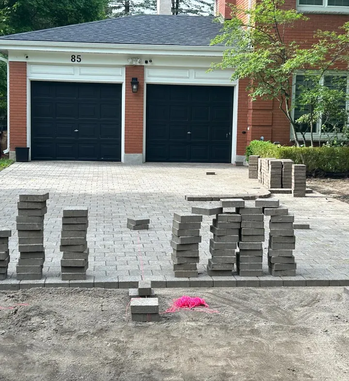 Block Paved Driveway Installation in Kilkenny Block paved driveway being laid in front of a double garage in Kilkenny